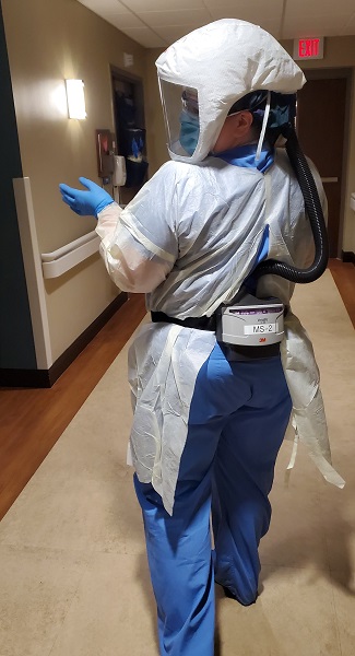 Elizabeth Tomaszewski, DNP, track director of the Adult-Gerontology Acute Care Nurse Practitioner Program (AGACNP) and assistant clinical professor, wearing PPE during her shift